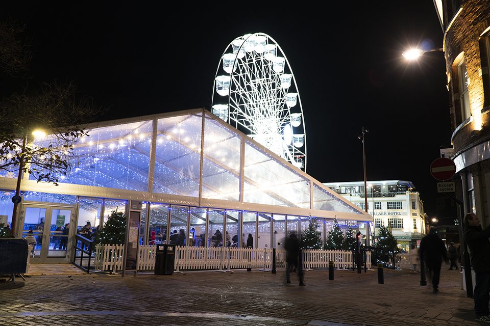 Wheel of light behind the real ice rink at Jubilee Square in Leicester