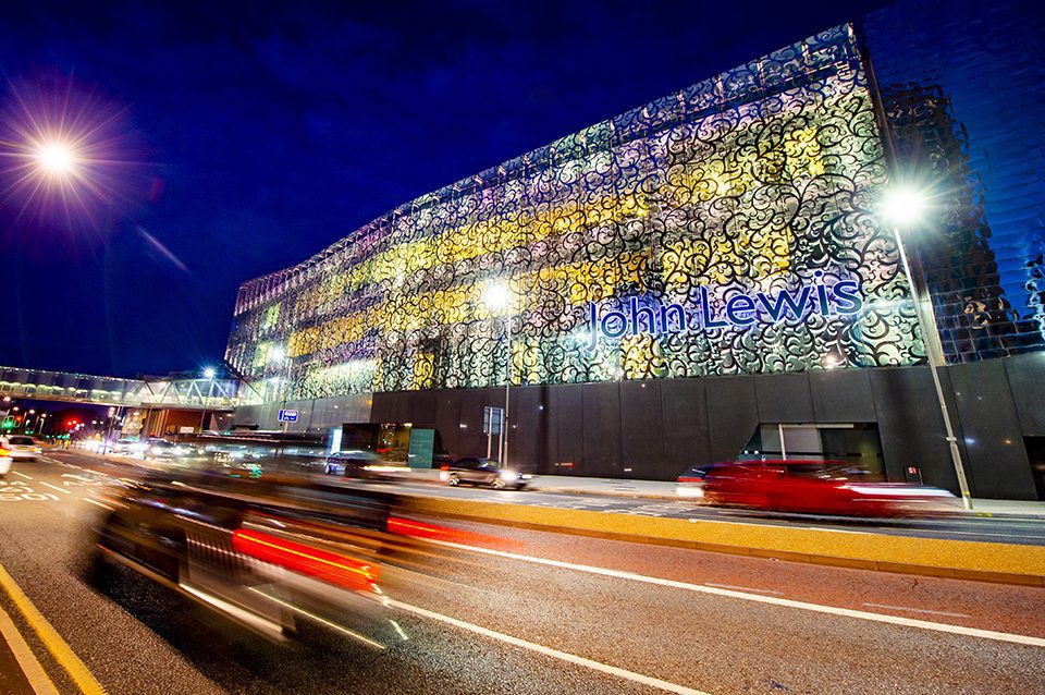 Cars driving past the John Lewis building in Leicester City Centre