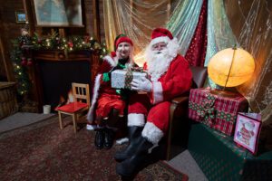 Santa and his elf in the grotto