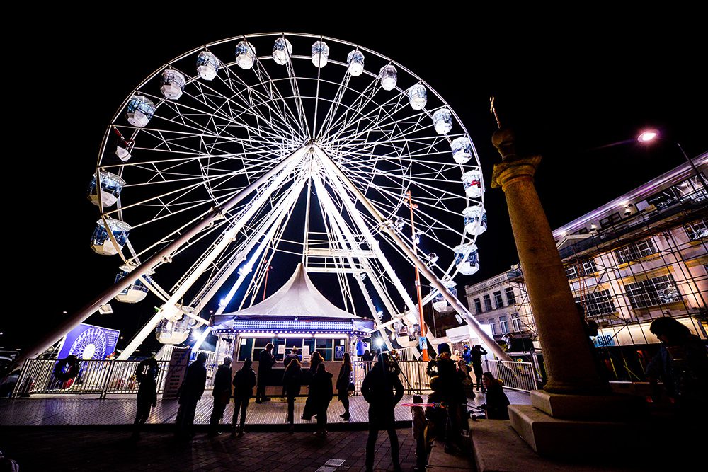 A crowd of people watching the Wheel of light at Jubilee Square in Leicester