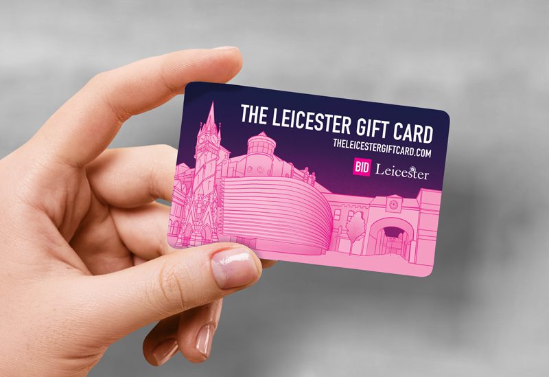 A hand holding The Leicester Gift Card