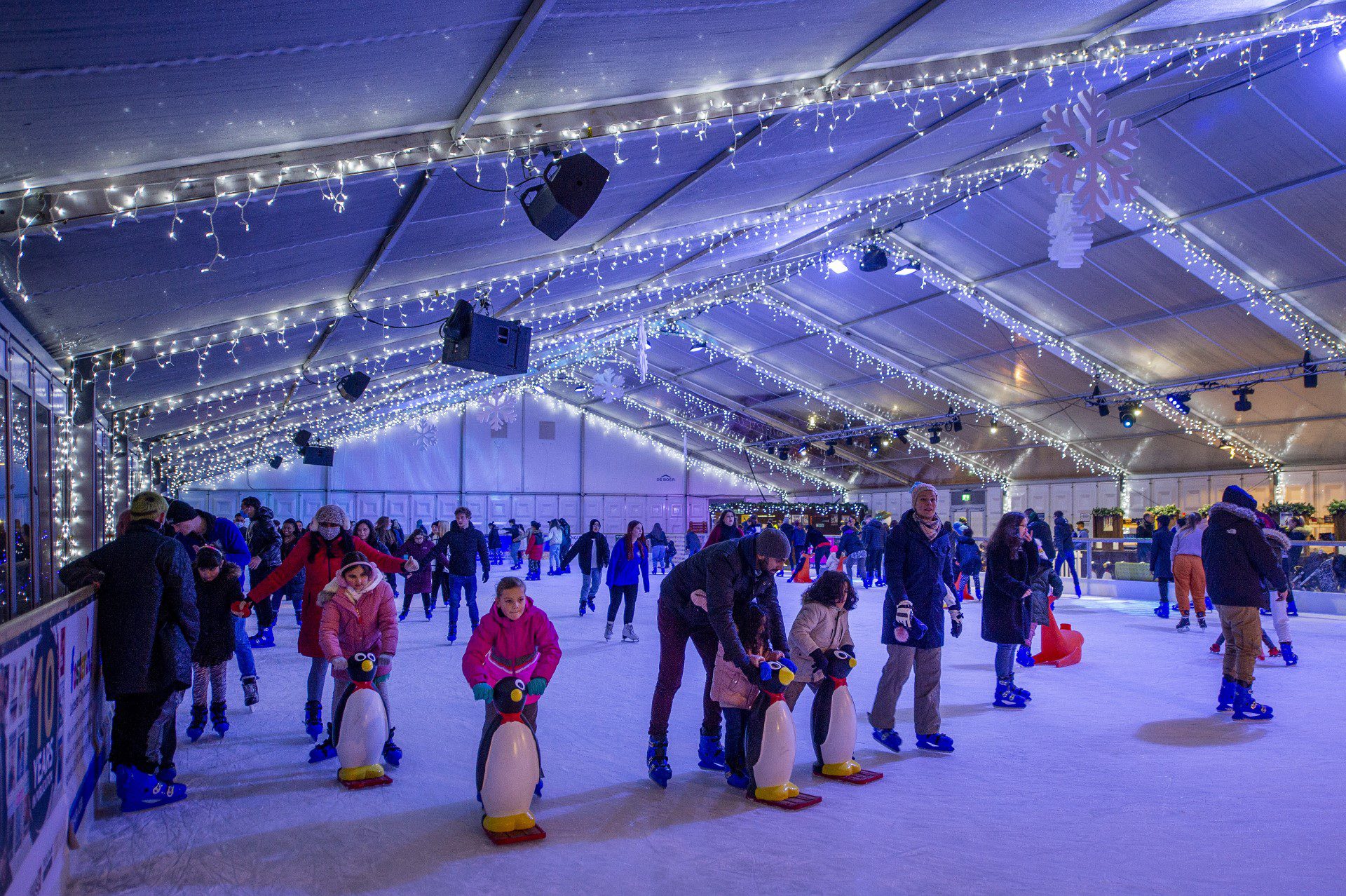 lots of people having fun skating on the Ice Rink at Jubilee Square in Leicester