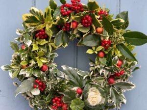 finished shot on door Wreath 1 Traditional with a twist made with garden foraged attached to oasis fgreen and white variegated foliage mixed leaves leaf red berries berry Herbs Ilex holly Aucuba japonica spotted laurel euonymus Cabbage Brasscia Ivy Hedera Malus crabapple 040214 04022014 04/02/2014 04/02/14 4 4th February 2014 Helen Riches Christmas decorations Winter Photographer Sarah Cuttle